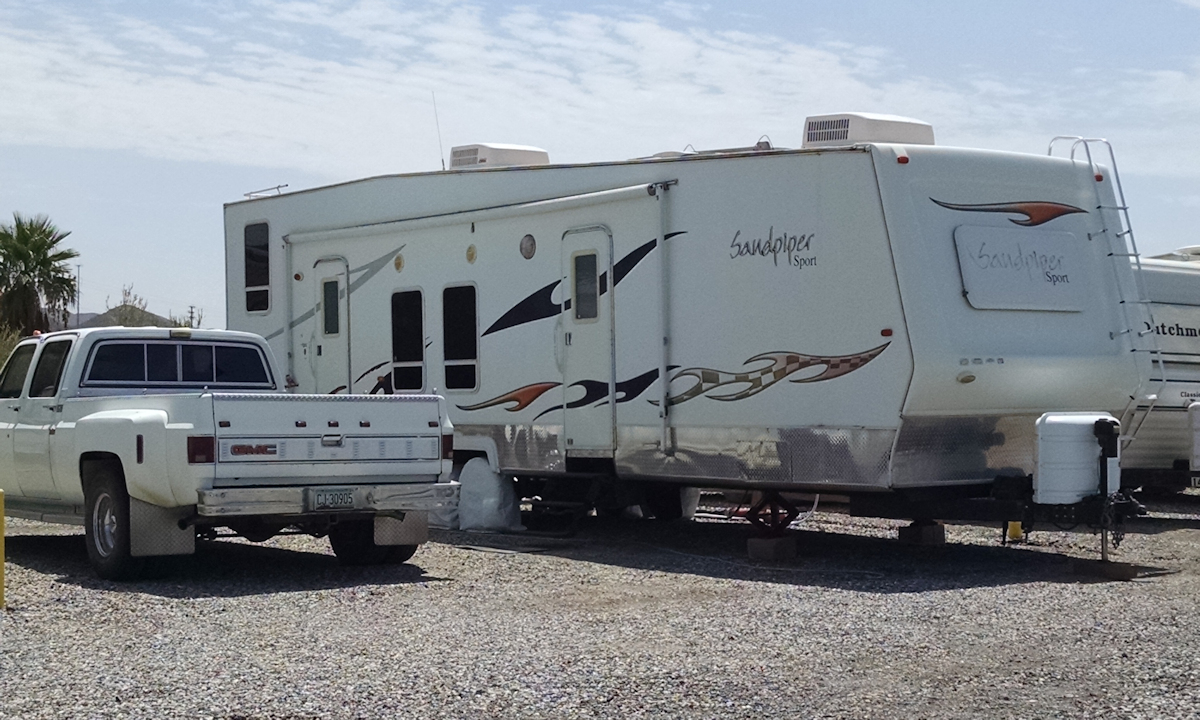 2006 34' Forest River Sandpiper Sport SP34T parked with 1982 GMC 454 ci 1-ton dually